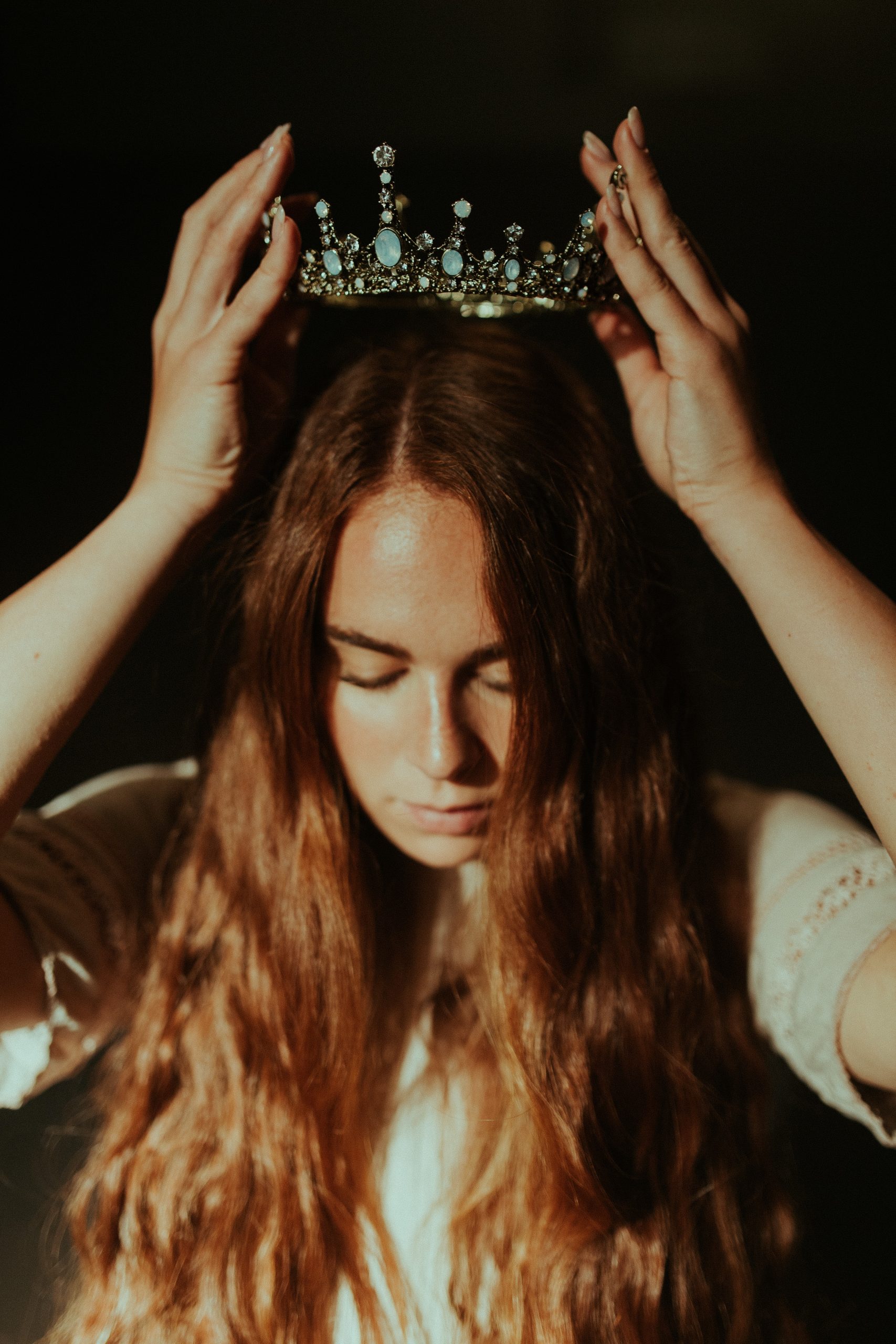 A young woman puts on her crown as she remembers she is a daughter of God.